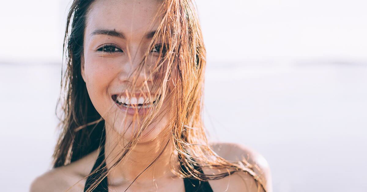 Woman on beach getting vitamin D